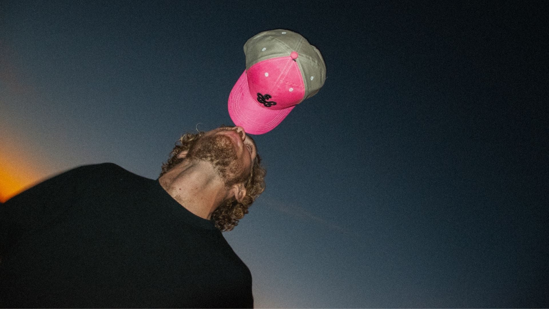 UPWIND founder wearing upcycled kitesurfing sail cap — sustainable fashion brand