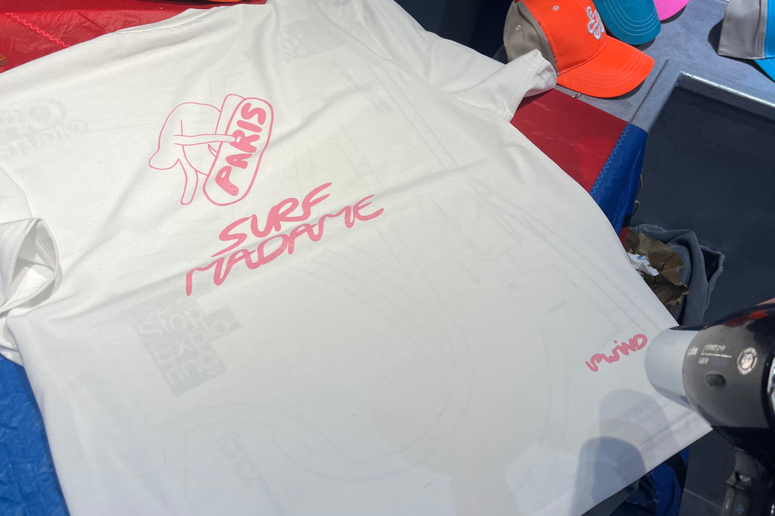Close-up of UPWIND serigraphy screenprint being applied to a white recycled t-shirt at a Paris event