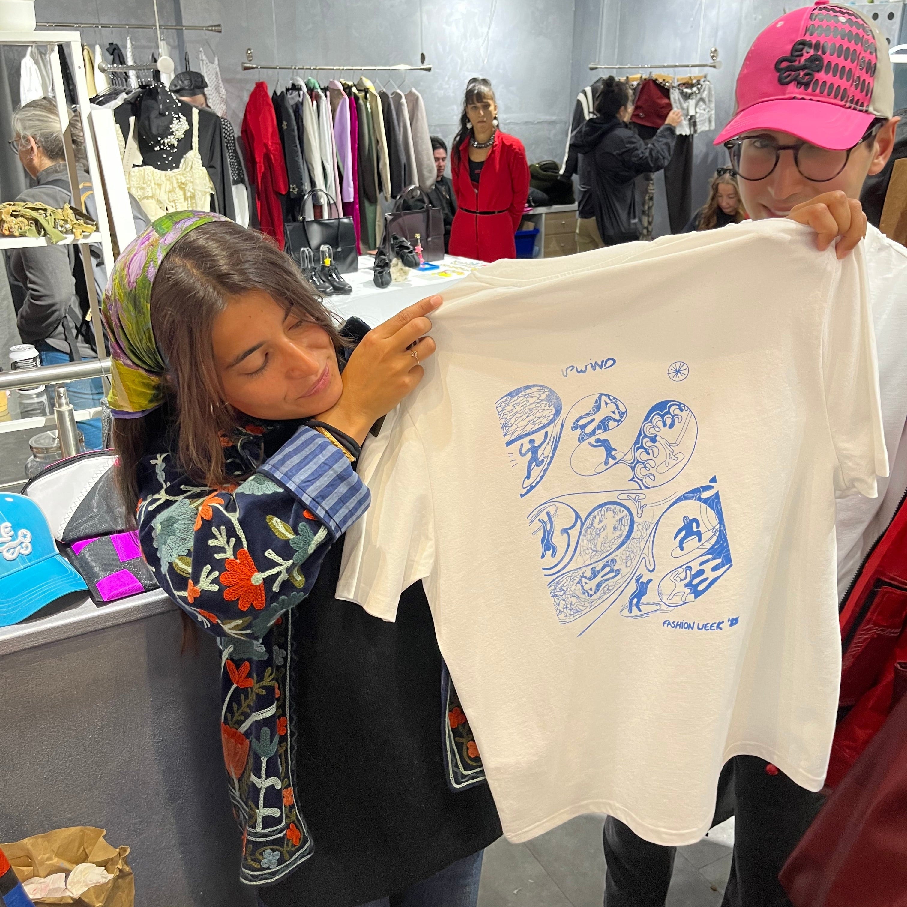 Attendee choosing serigraphy design at UPWIND custom t-shirt screenprinting workshop
